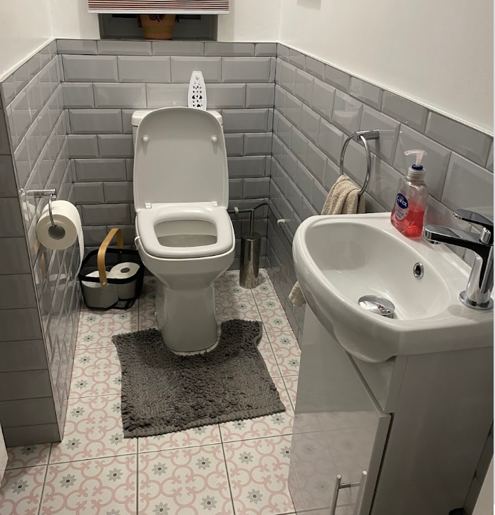 Professional bathroom installation by R Oakley Plumbing showing modern grey tiling, white fixtures, and quality workmanship